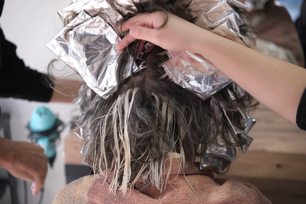 Photo by Doğan Alpaslan Demir A detailed shot of hair coloring process using foils at a salon in İzmir, Türkiye.